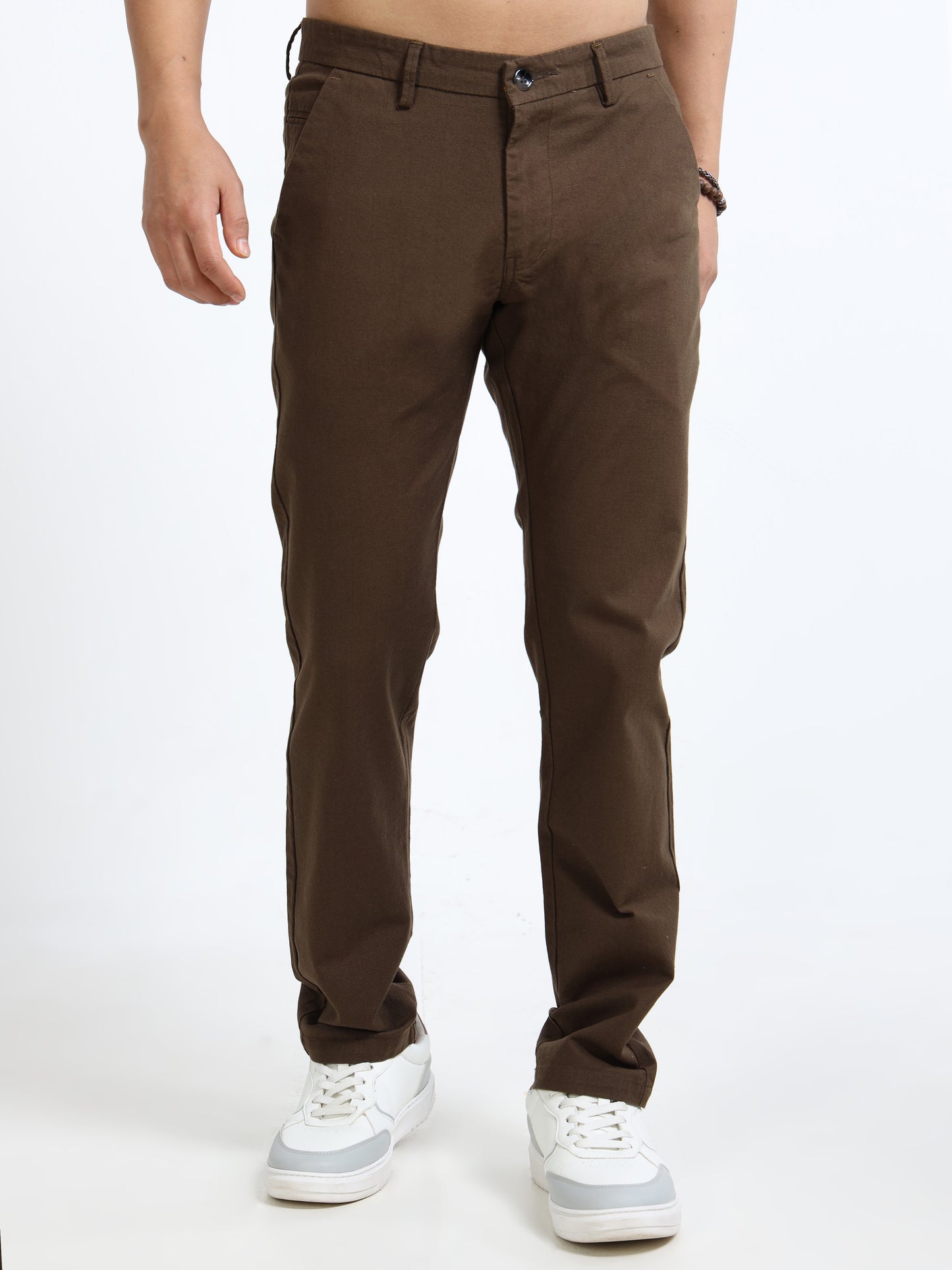 Brown pants worn by a person on a white background