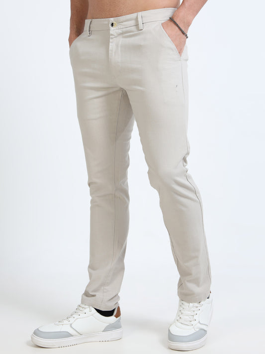 Beige pants worn by a person on a white background