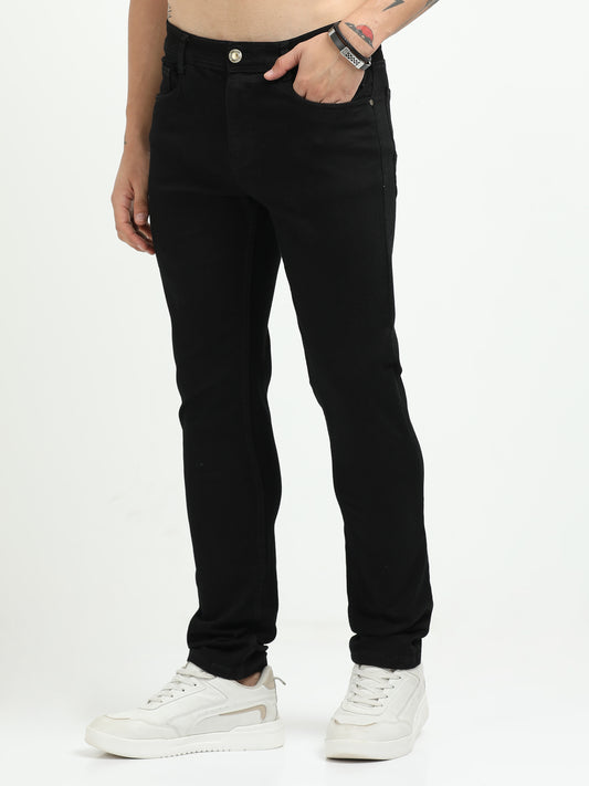 Person wearing black jeans on a white background
