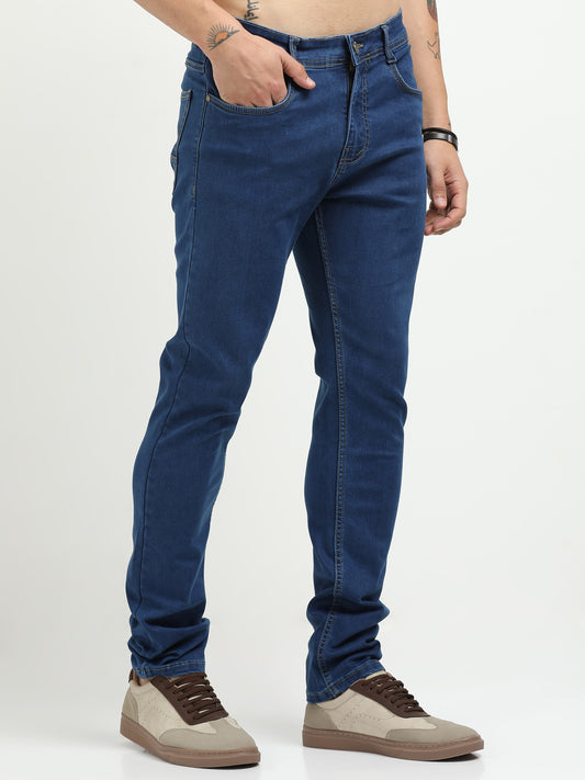 Blue jeans worn by a person on a white background