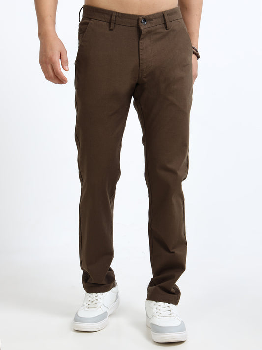 Brown pants worn by a person on a white background