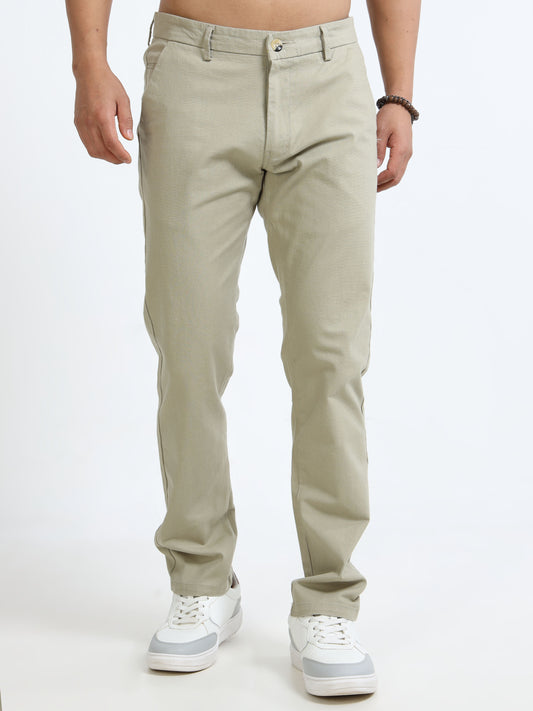 Beige pants worn by a person on a white background