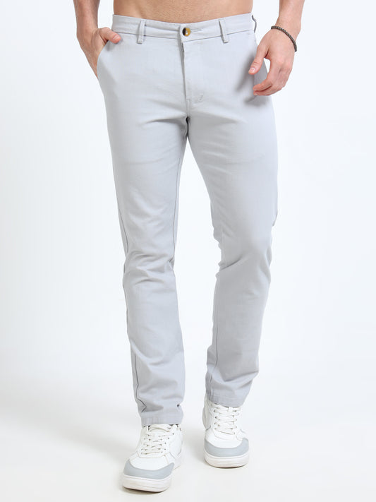 Light gray pants worn by a person on a white background