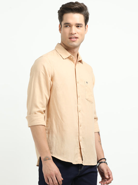 Man wearing a beige shirt on a white background