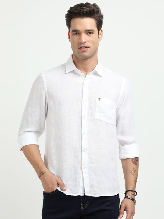 Man wearing a white shirt on a plain background