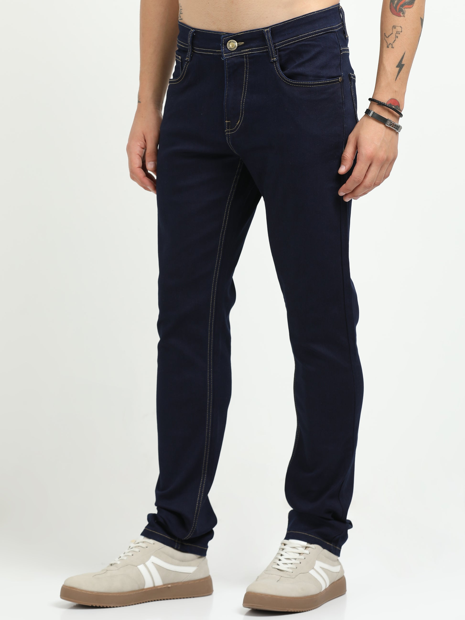 Person wearing dark blue jeans on a white background