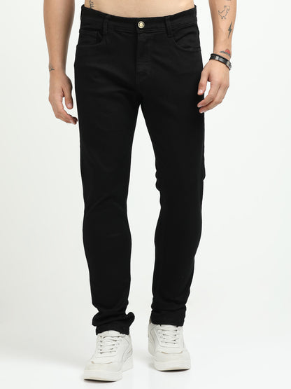 Person wearing black jeans on a white background