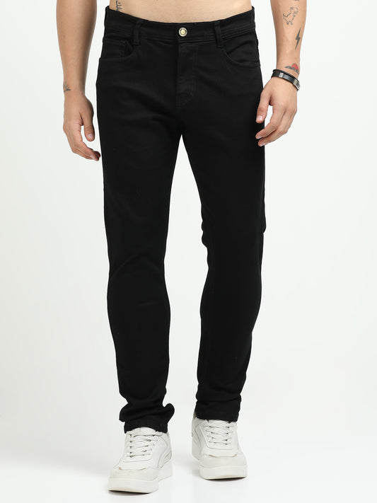 Person wearing black jeans on a white background