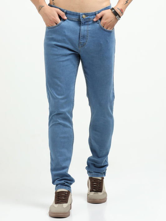 Person wearing blue jeans on a white background