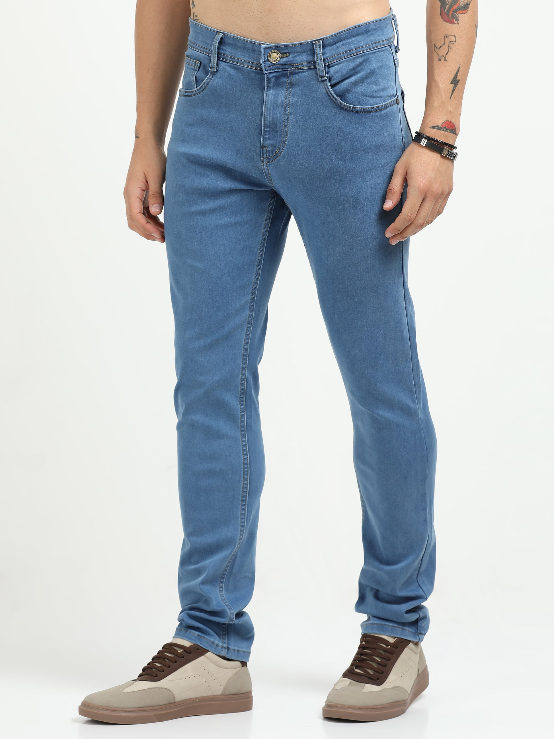 Person wearing blue jeans on a white background